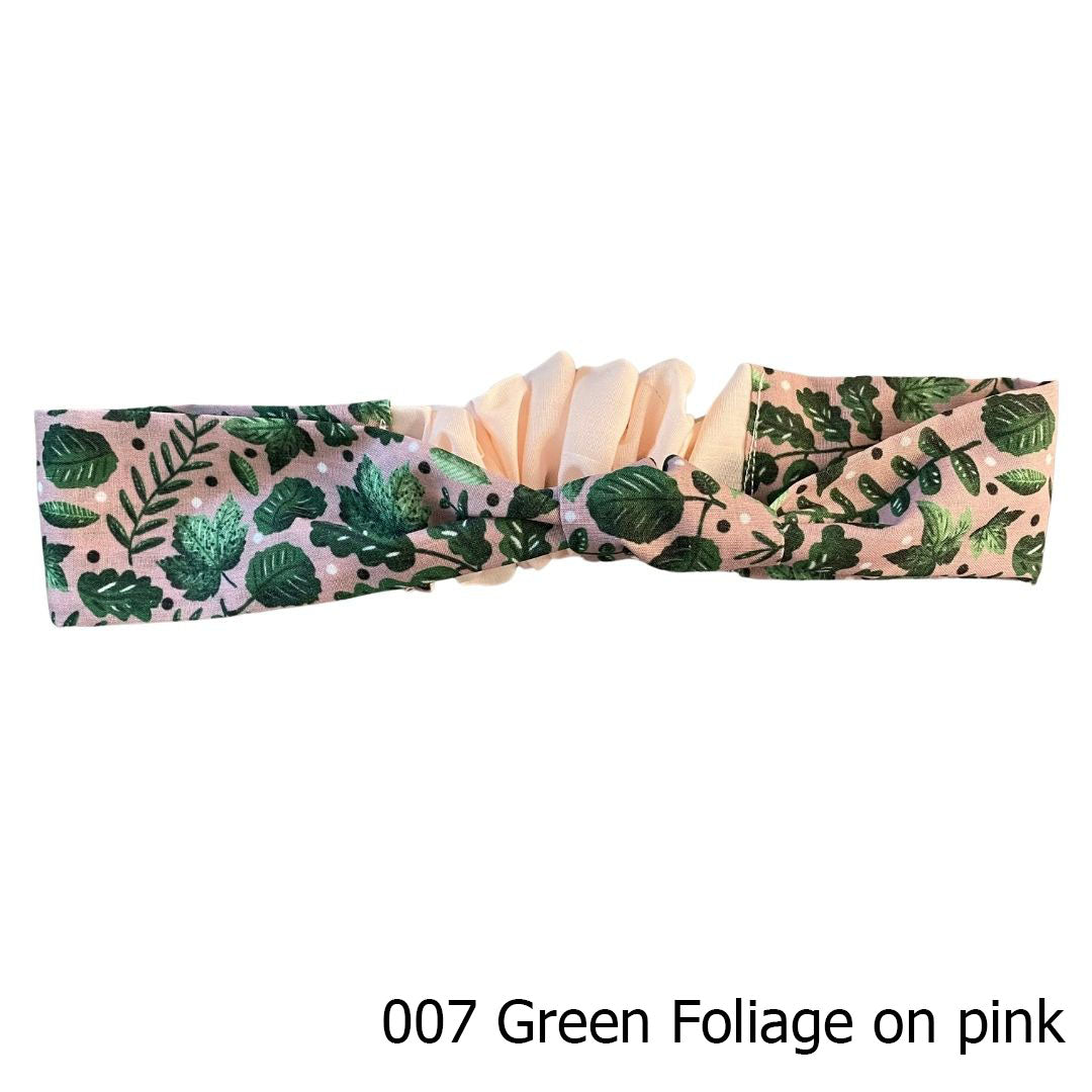 green foliage patterned headband on white background